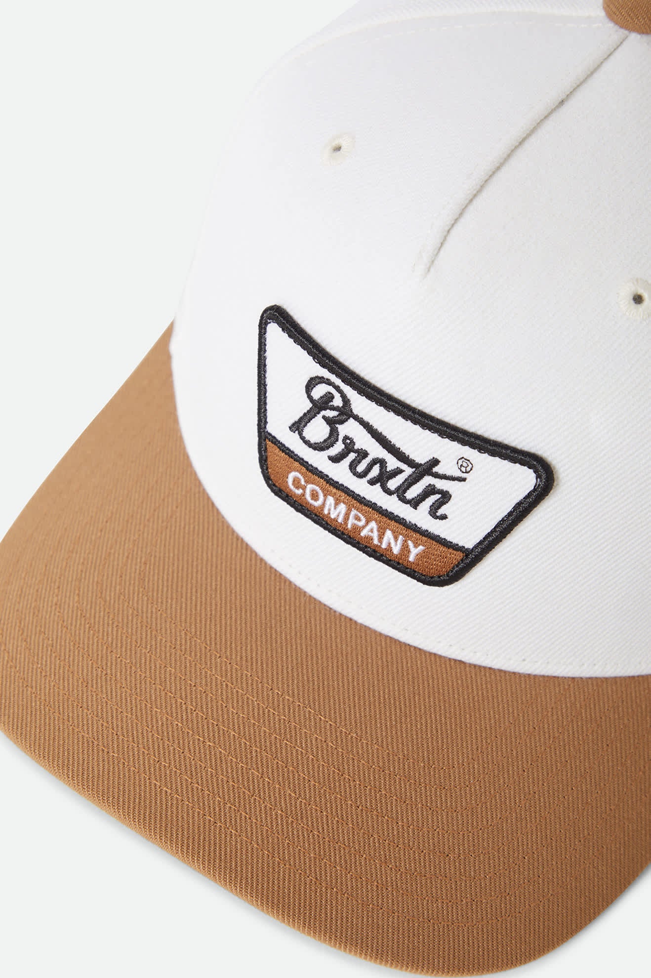 white and tan Brixton hat